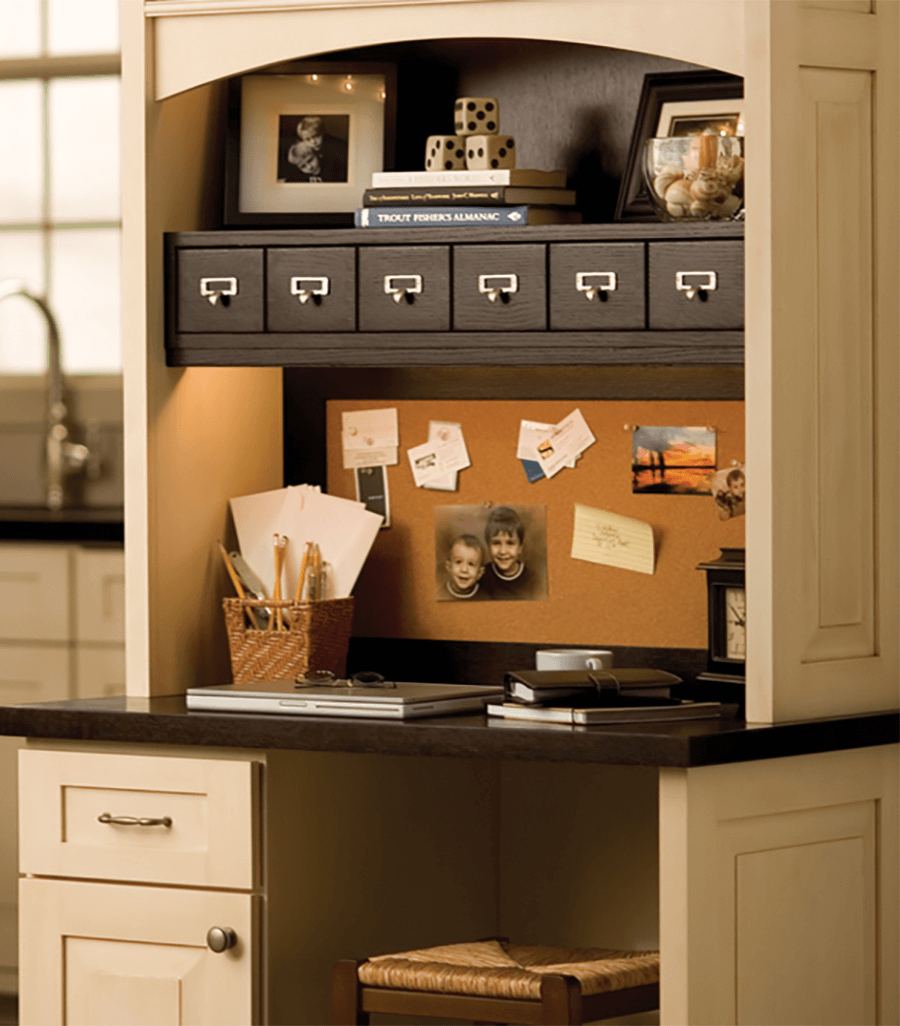 An office desk in a kitchen. Kitchen cabinets and office desk by Dura Supreme Cabinetry.