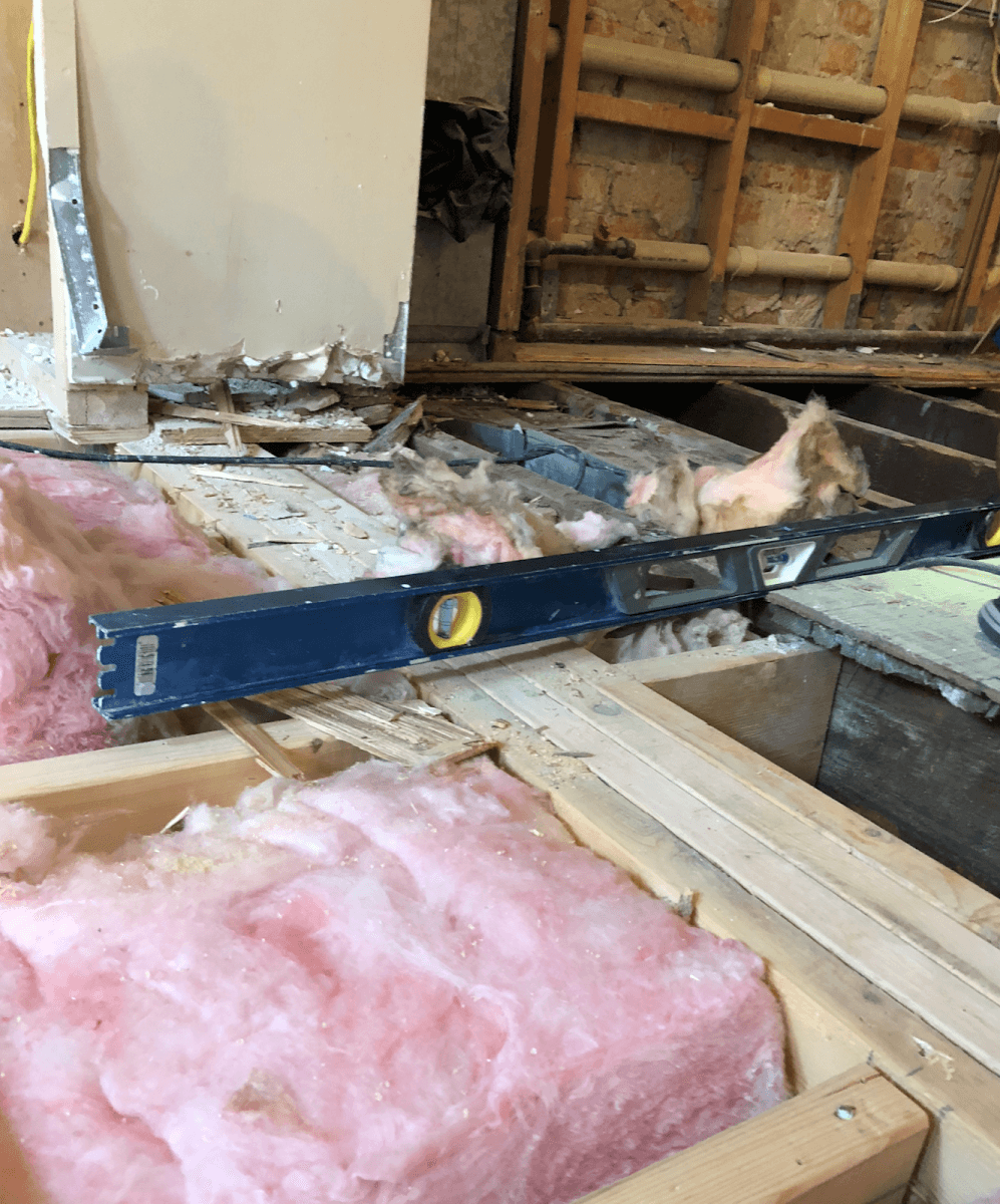 To solve the issue of the floor slope, contractors sistered the floor joists along the entire first floor to set a solid foundation for the new flooring and cabinetry.