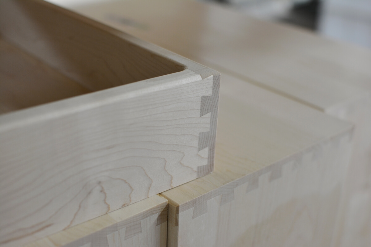 A dovetail drawer box from Dura Supreme Cabinetry shown during construction on the factory floor.
