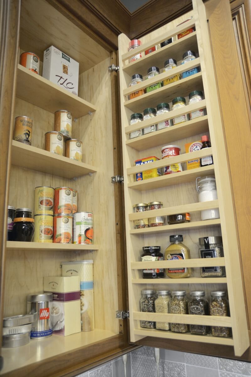 A traditional Door Spice Rack from Dura Supreme offers convenient kitchen storage in a wall cabinet. Kitchen cabinet storage from Dura Supreme Cabinetry.
