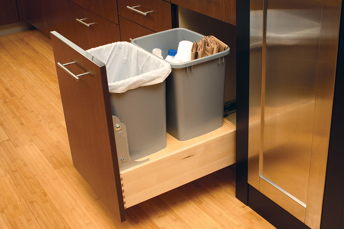 A m-out cabinet with two trash bins for waste and recylcing. Kitchen Cabinets and Storage from Dura Supreme Cabiinetry.