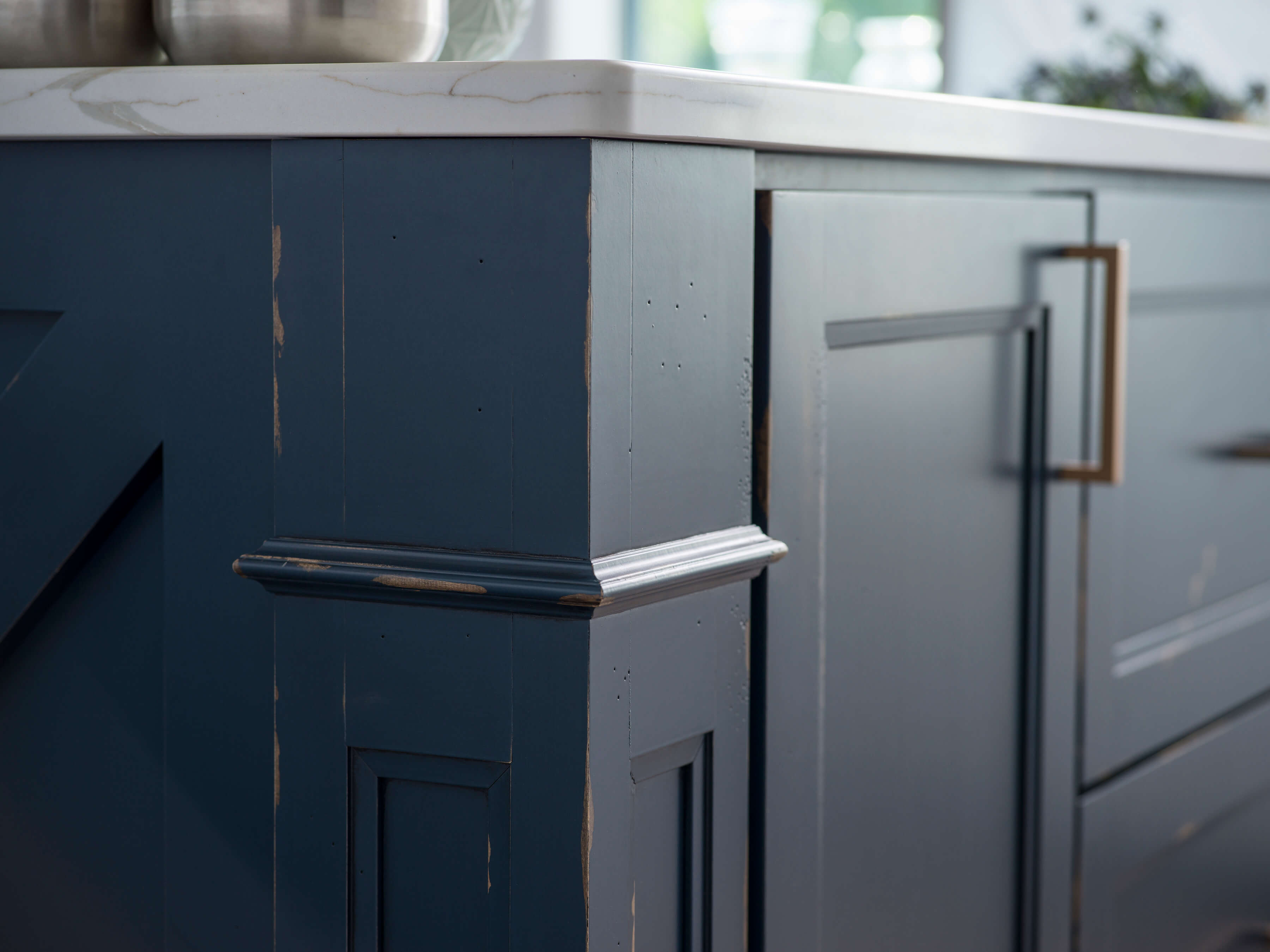 A kitchen island with a beautiful distressed paint finish with Dura Supreme's Heritage Paint finish in a custom Navy blue color.