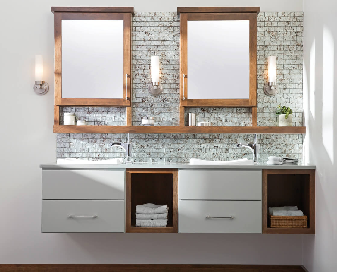 Floating vanity with two-toned wall hung bathroom cabinets from Dura Supreme Cabinetry.