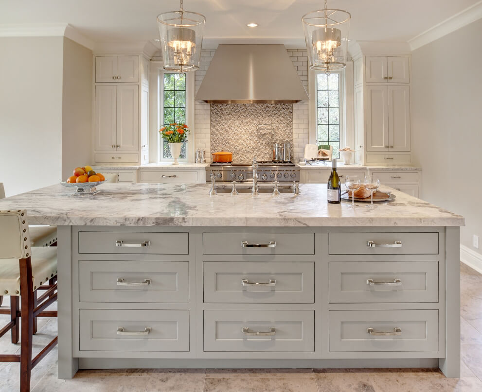 Gray painted kitchen island with off-white painted perimeter cabinets. This warm and bright kitchen combines white and gray finishes beautifully.