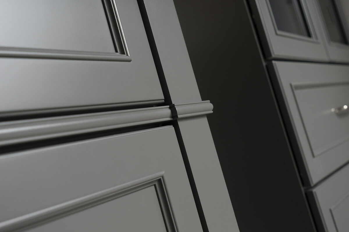 A close up of bathroom vanity cabinets and cabinet doors with a dark gray painted finish..