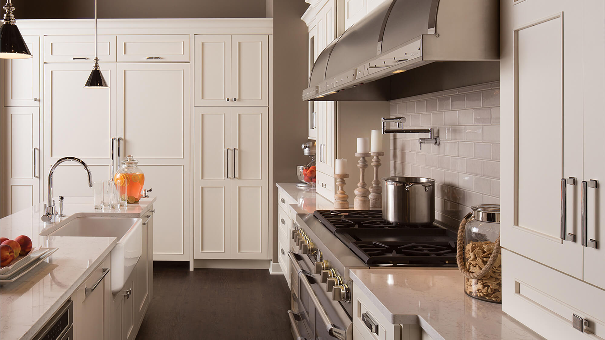 An casual styled kitchen with frameless kitchen cabinets with white and beige painted finishes.