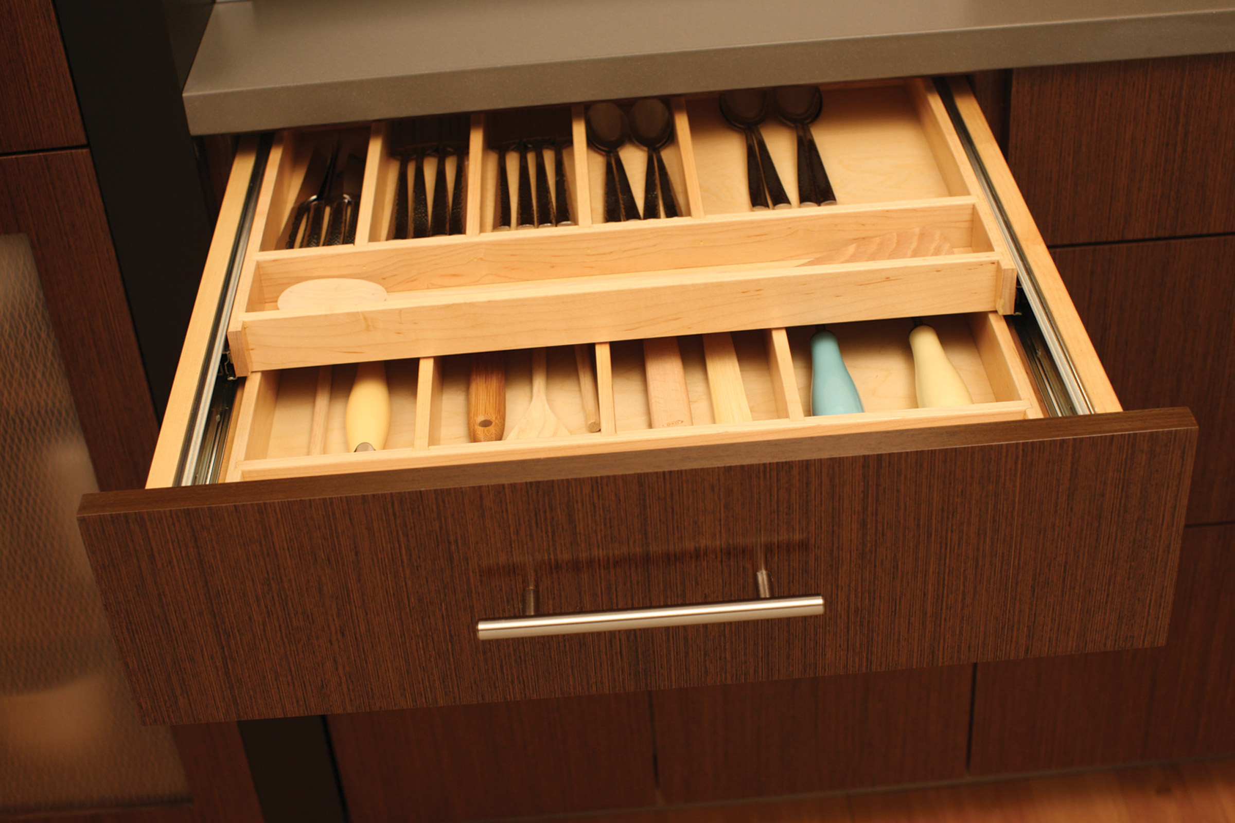Maximize drawer space with a Two-Tier Wood Cutlery Tray (TTWCT-A) to organize silverware and utensils on two levels within the drawer.