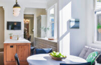 A traditional styled galley kitchen with a warm stained kitchen island and cool gray painted cabinets for the perimeter.