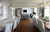 A look out to the living room from the kitchen in a East Coast Shingle styled home.