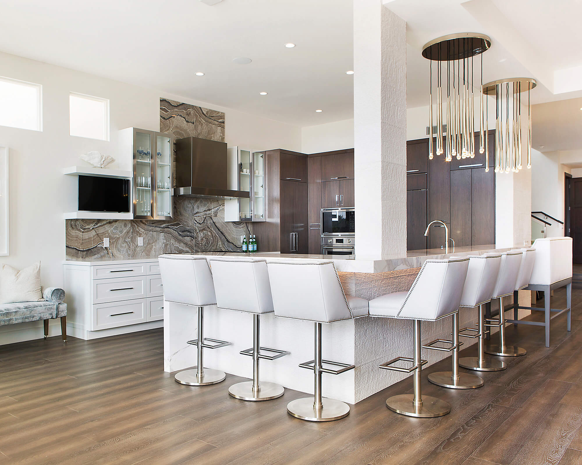 Kitchen peninsula ideas for large kitchens. This large kitchen design features a long L-shaped kitchen peninsula with seating for 8 to 10 bar stools.