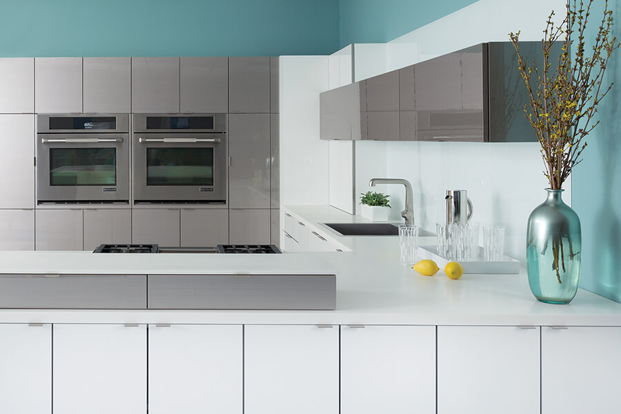 Modern frameless kitchen cabinetry showing acrylic and wired foil contemporary cabinet materials from Dura Supreme cabinetry's Bria Cabinetry product line.