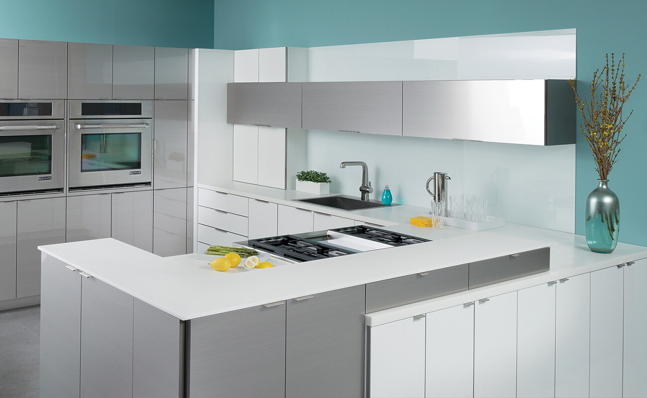 This kitchen combines white acrylic cabinets with metal-like Wired Gloss foil cabinets with a silver color like stainless steel.