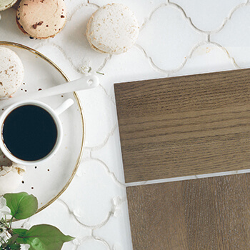 A kitchen design idea with a pretty slab style cabinet door in a gray-brown stain color on white tiles.