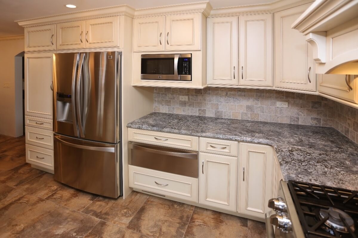 A Dura Supreme kitchen design by Seigle's Cabinet Center showing recommended landing space near a microwave oven.