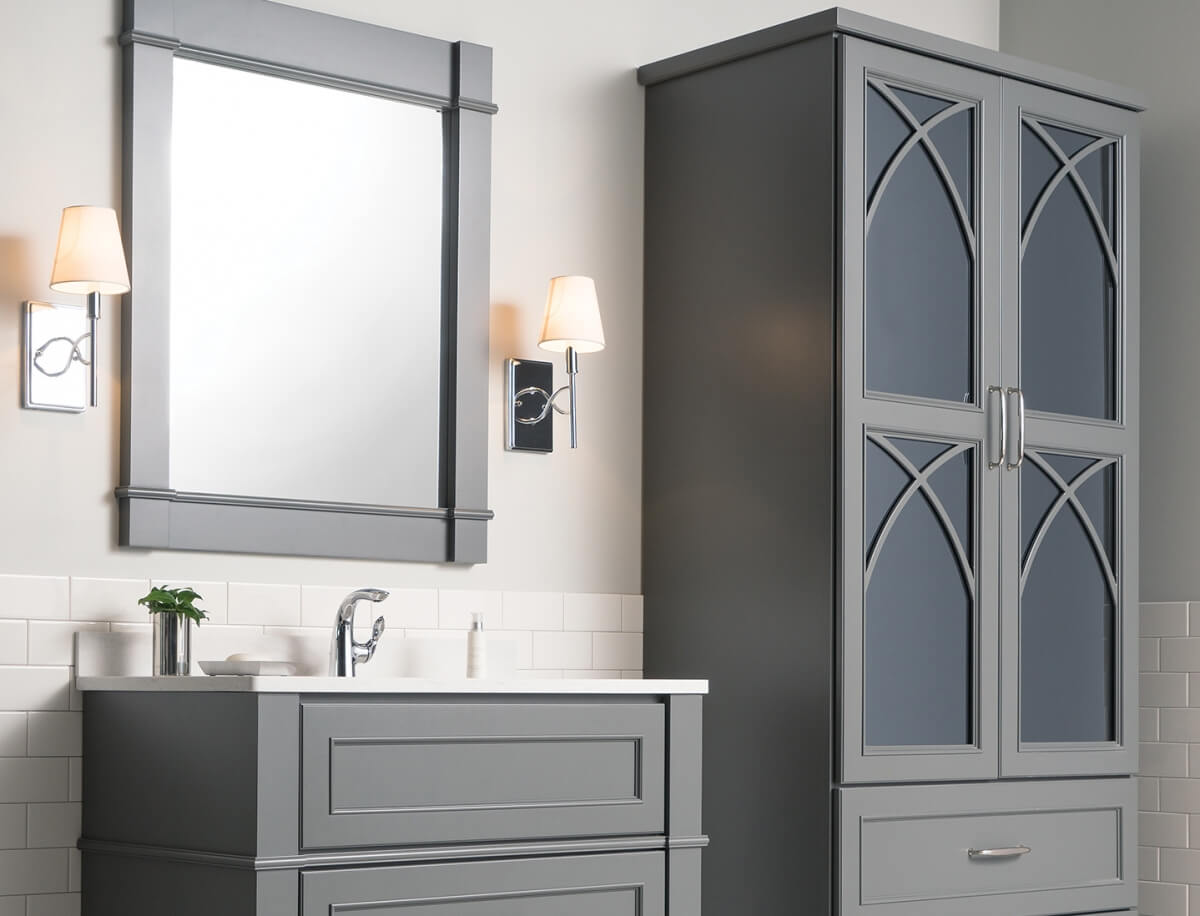 Dark gray bathroom furniture and vanity cabinets with delicate mullion cabinet doors with a dark gray mirror cabinet door insert.