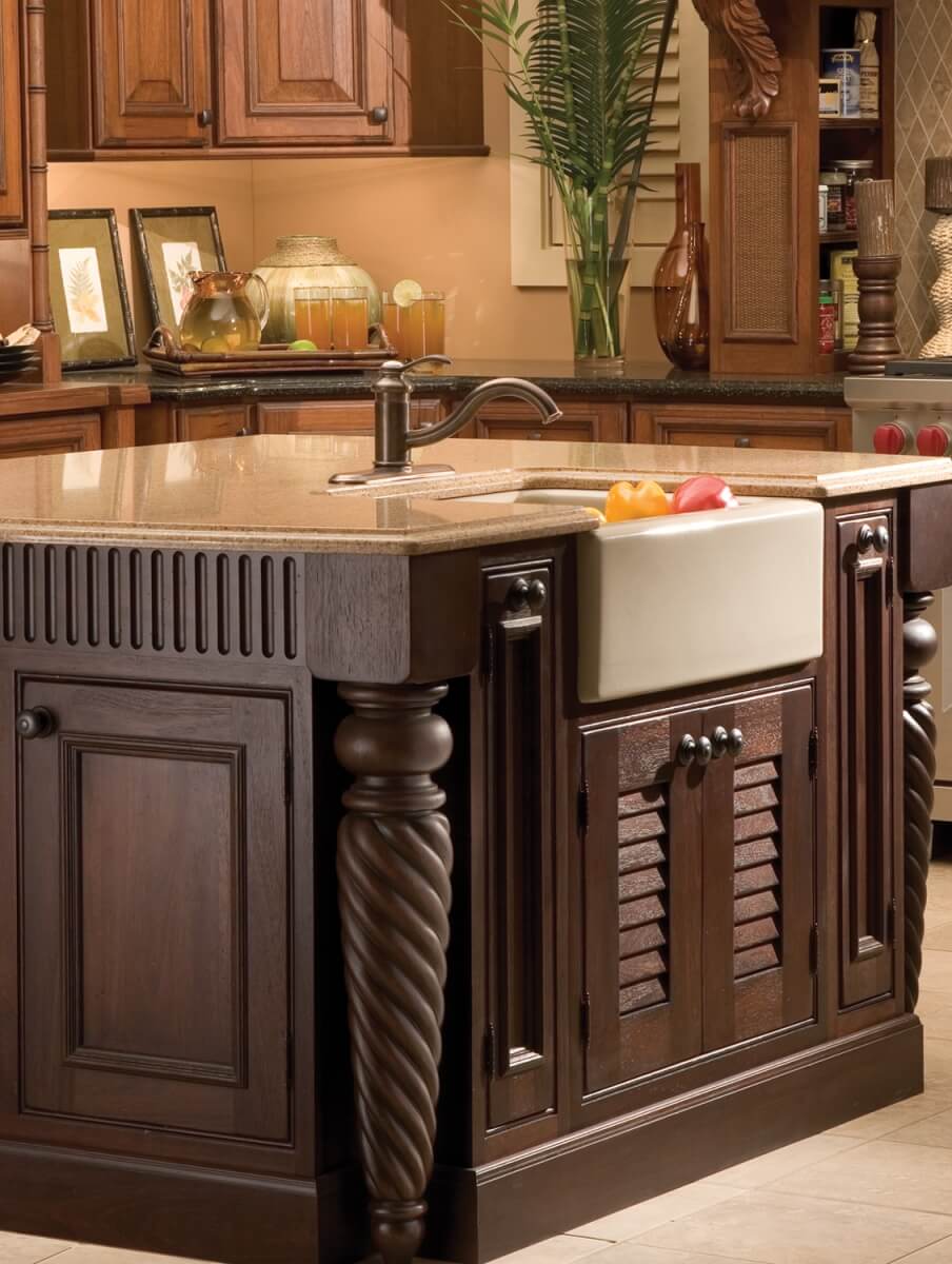 A traditional furniture-styled kitchen island with decorative turned posts and well-planned molding can create a centerpiece for your tropical-inspired kitchen.