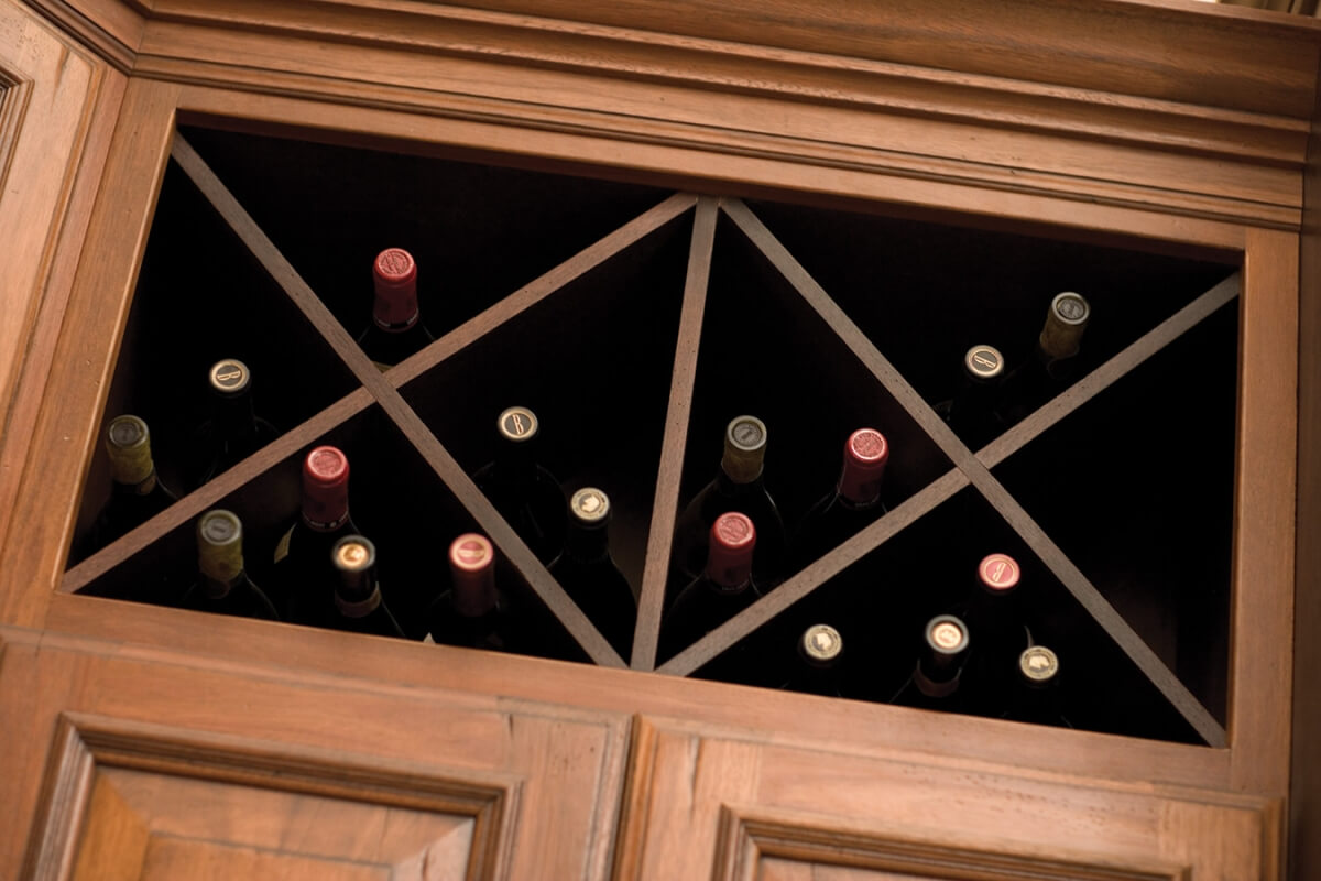 An “X” wine rack in an open kitchen cabinet offers convenient and beautiful wine storage.
