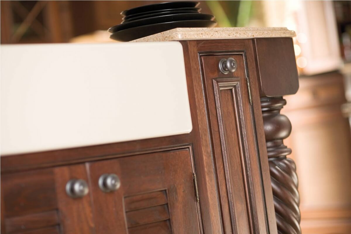 Inset cabinetry with decorative barrel hinges can help create the look of a historic piece of furniture.