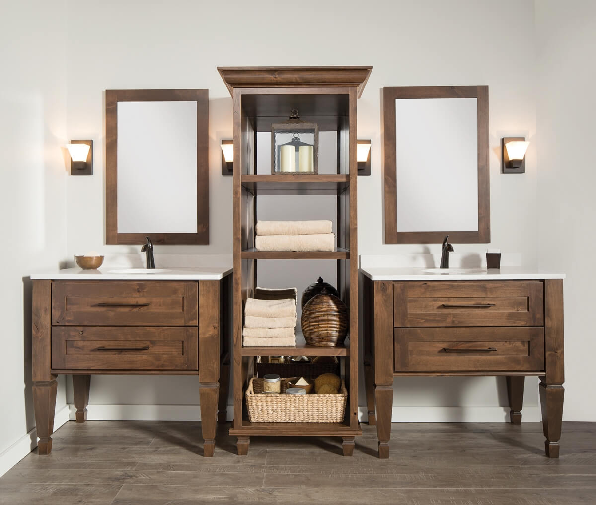 A master bathroom with double vanities featuring a tall freestanding linen cabinet with a mirror in the back of the cabinetry.