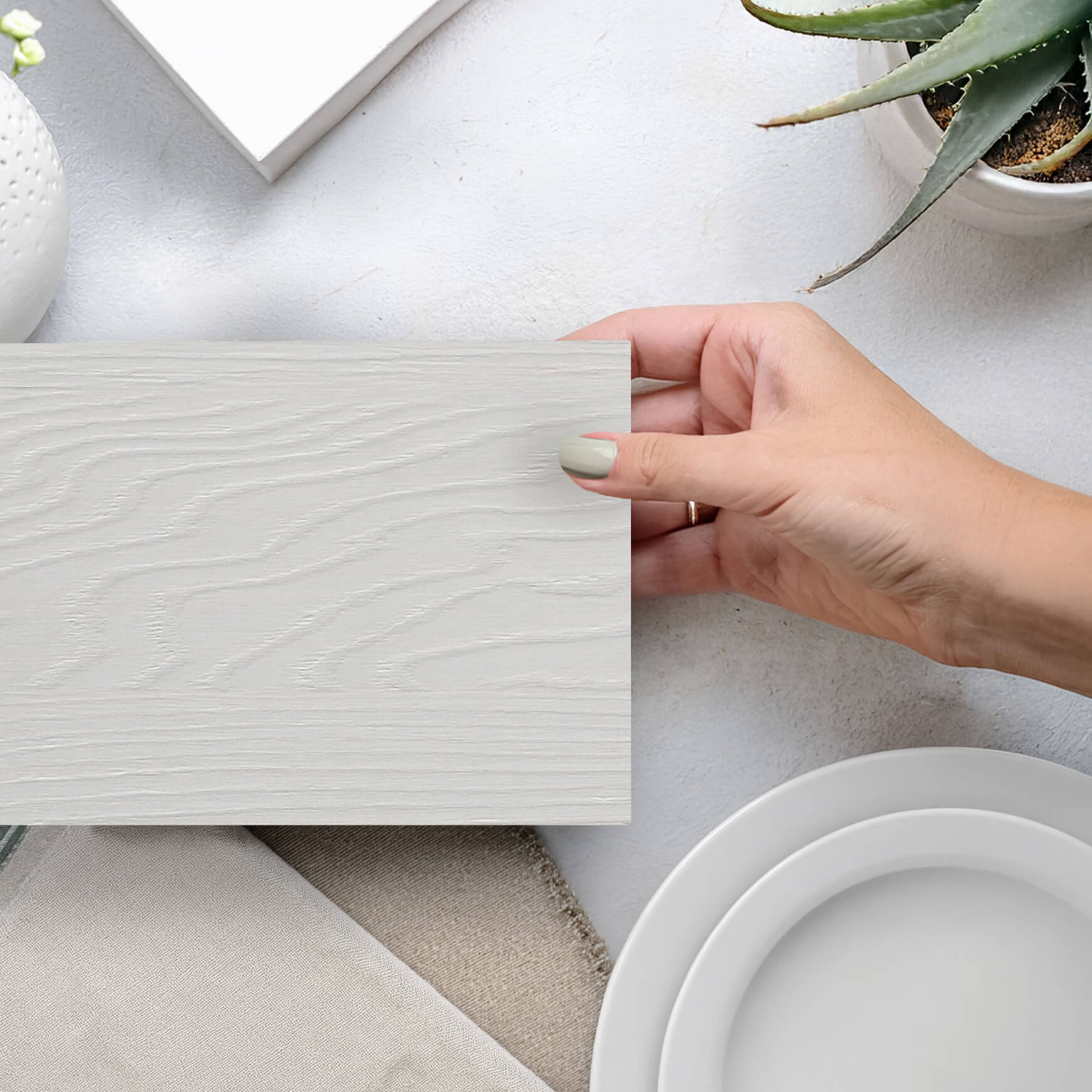 White textured Sculpted TFL cabinetry finish features a horizontal grain pattern that brings depth and visual interest to modern slab door cabinets. The contemporary surface combines clean lines, subtle texture, and a bright, sophisticated aesthetic.