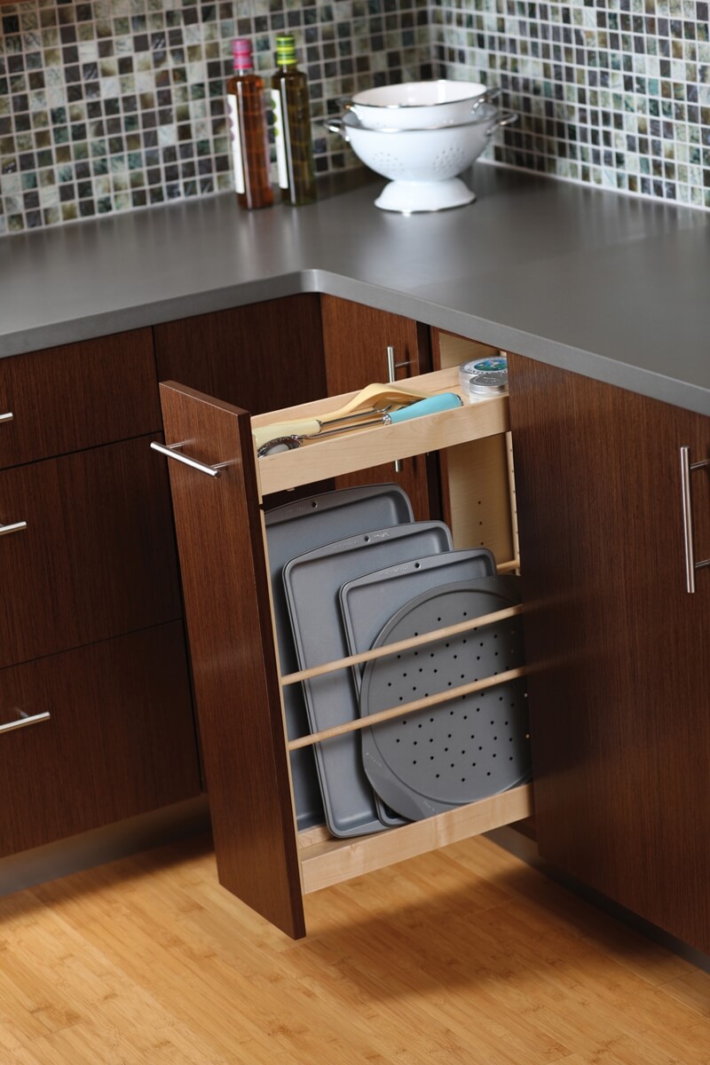 A Pull-Out Tray Cabinet from Dura Supreme offers practical and convenient use of space and works great for storing pans and cookie sheets in small spaces.