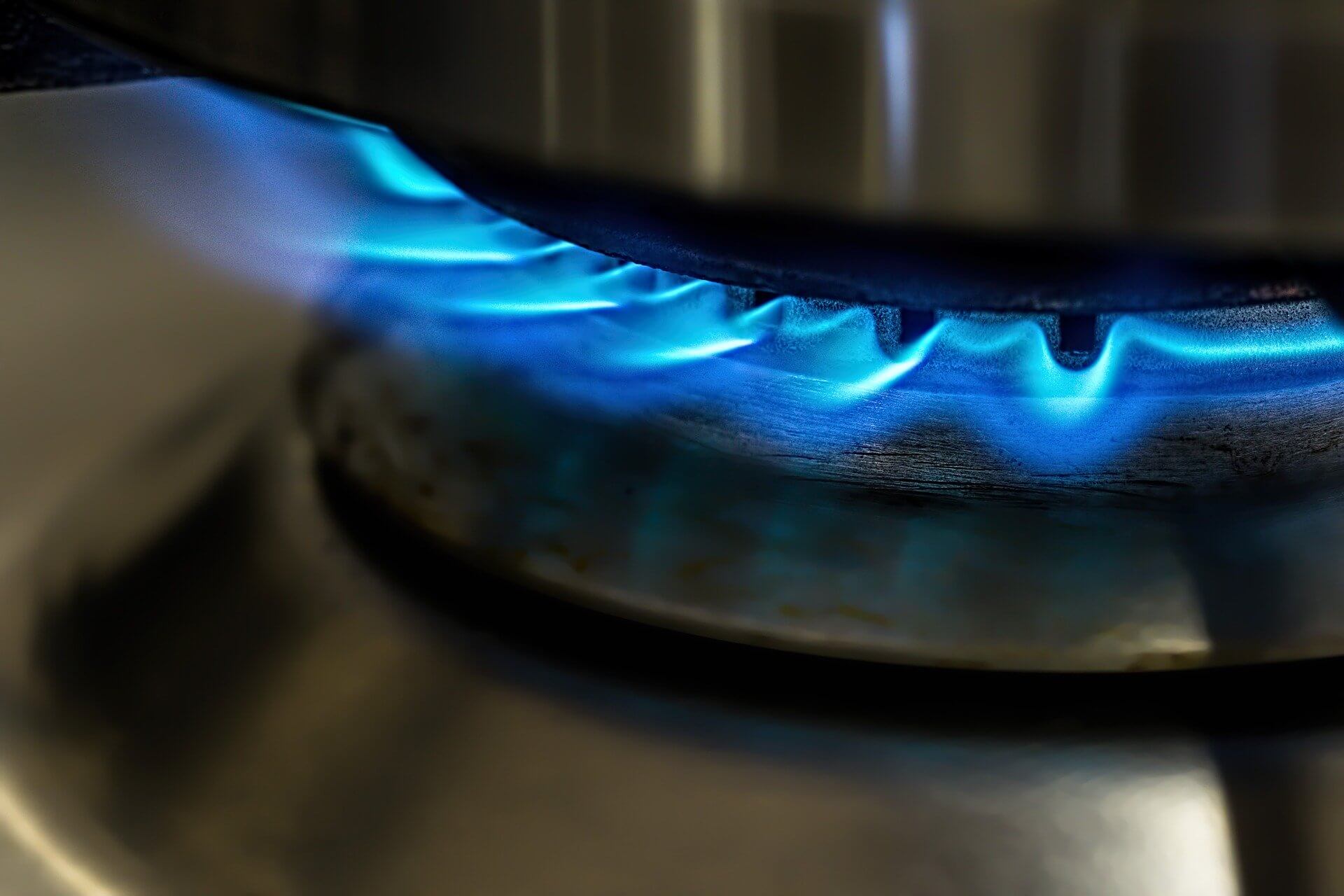 A close up of a gas burner on a stove top.