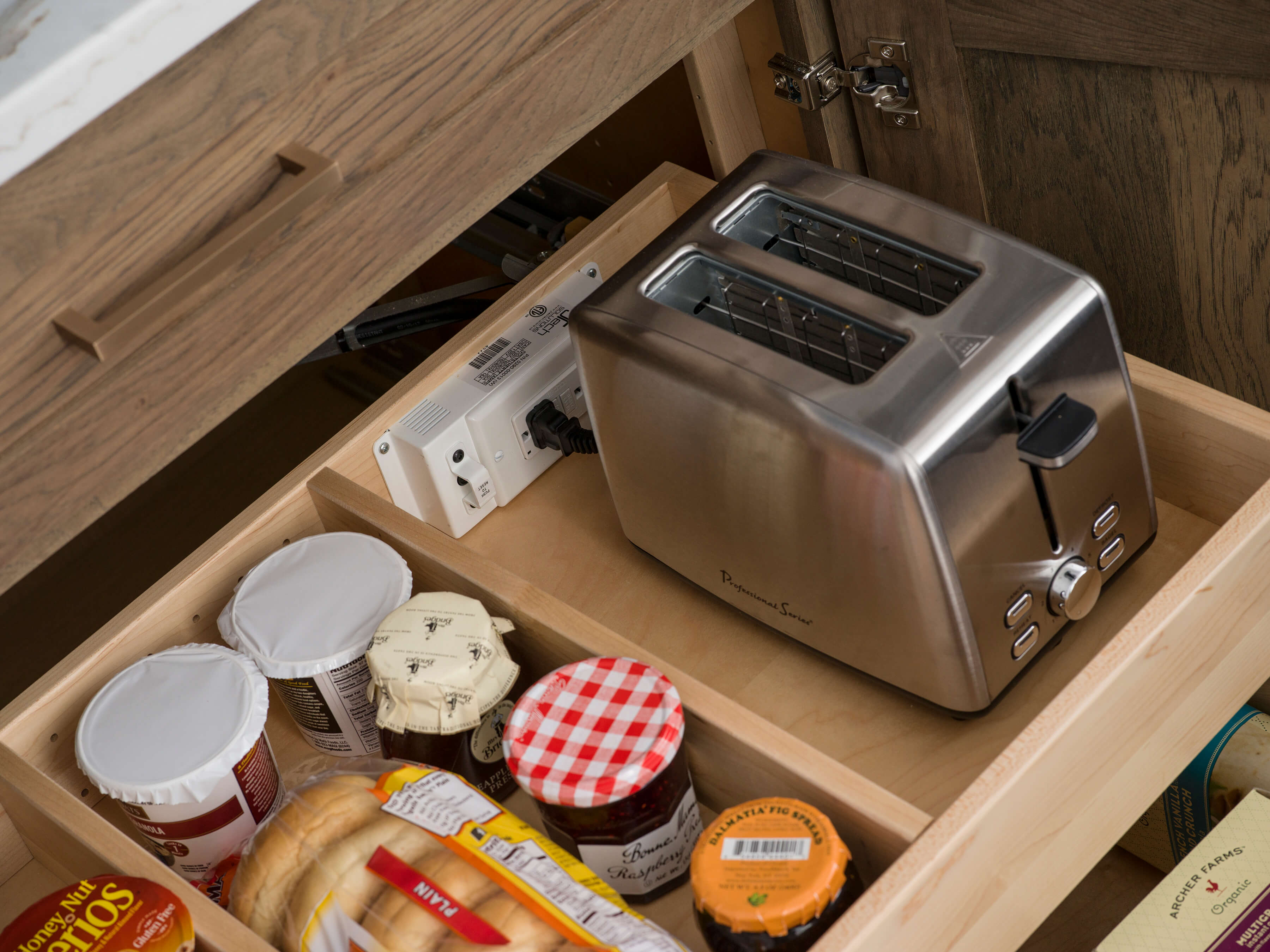 Add more function to a simple Roll-Out Shelf with a Power Station to house and power your small kitchen appliances, helping keep your counters clutter-free. Roll-out shelf storage in a base cabinet makes it easier to reach items in the back of the cabinet.