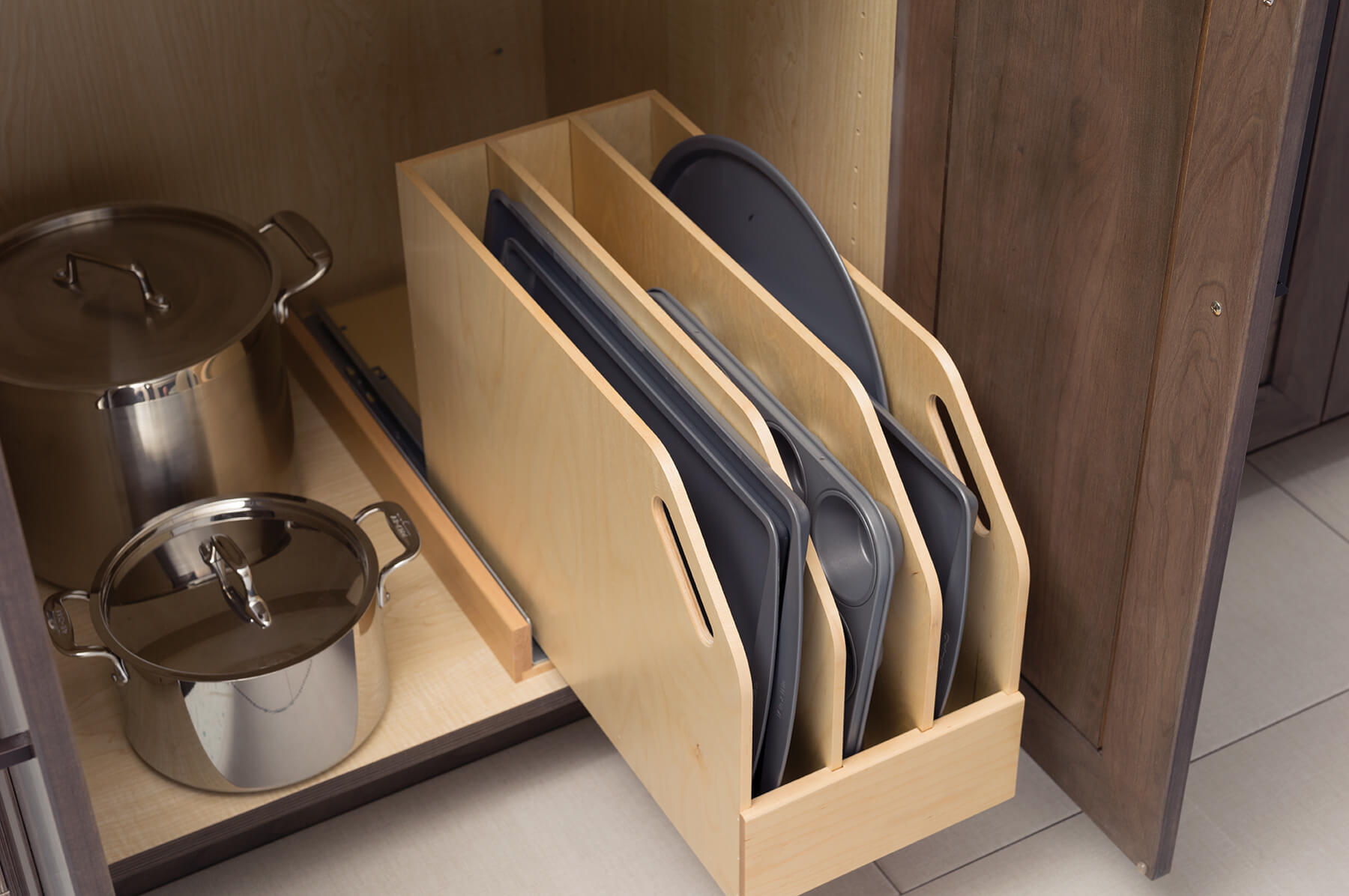 Trays, Pans, and cutting boards can be stored in a roll-out Tray Divider Pull-Out for practical and convenient use of space in a base cabinet.