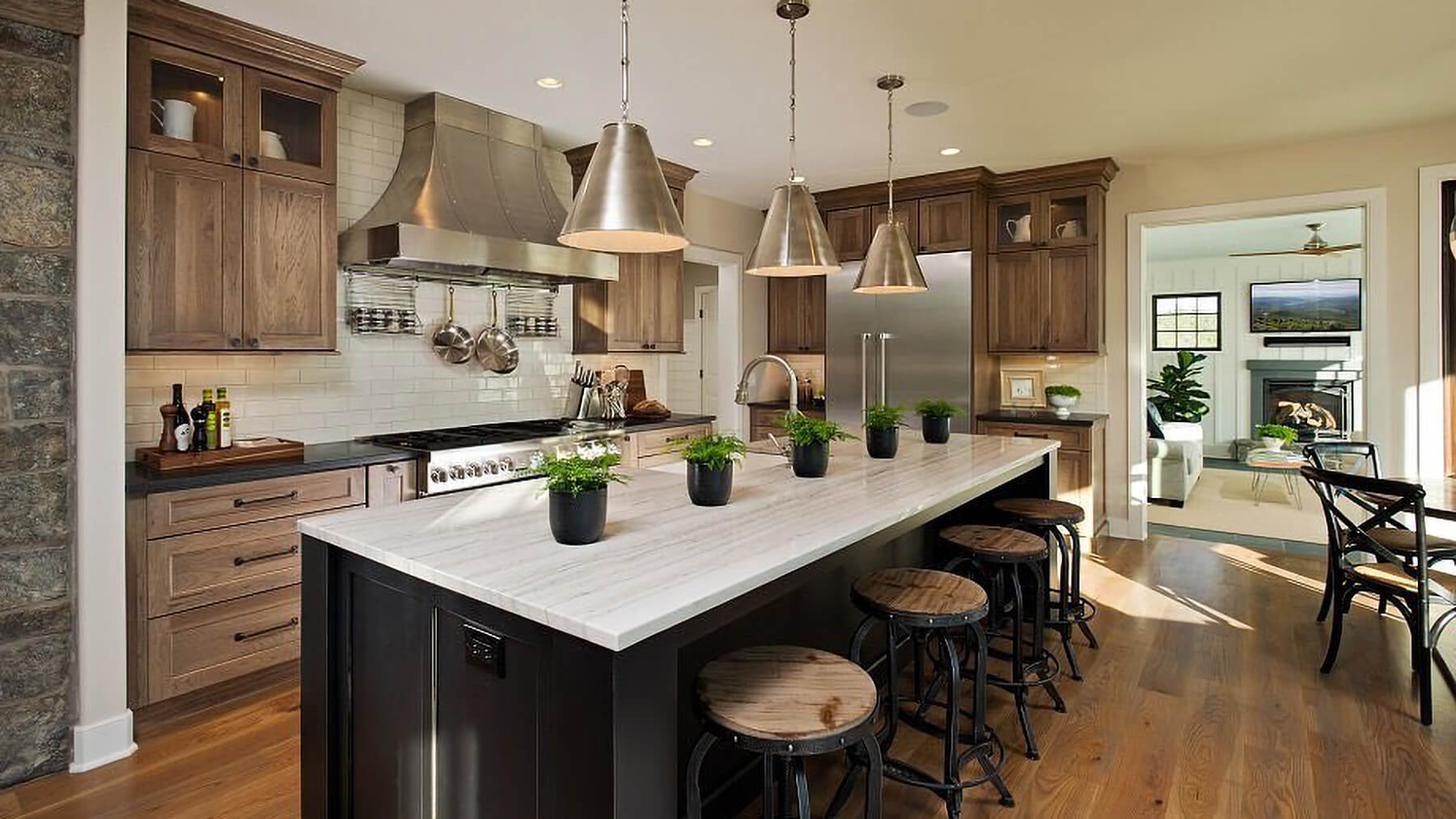 The perimeter cabinets are shown in Hickory with a Morel stain. Dura Supreme design by Witt Construction, Inc., Saratoga Springs, NY. Photography by Randall Perry.