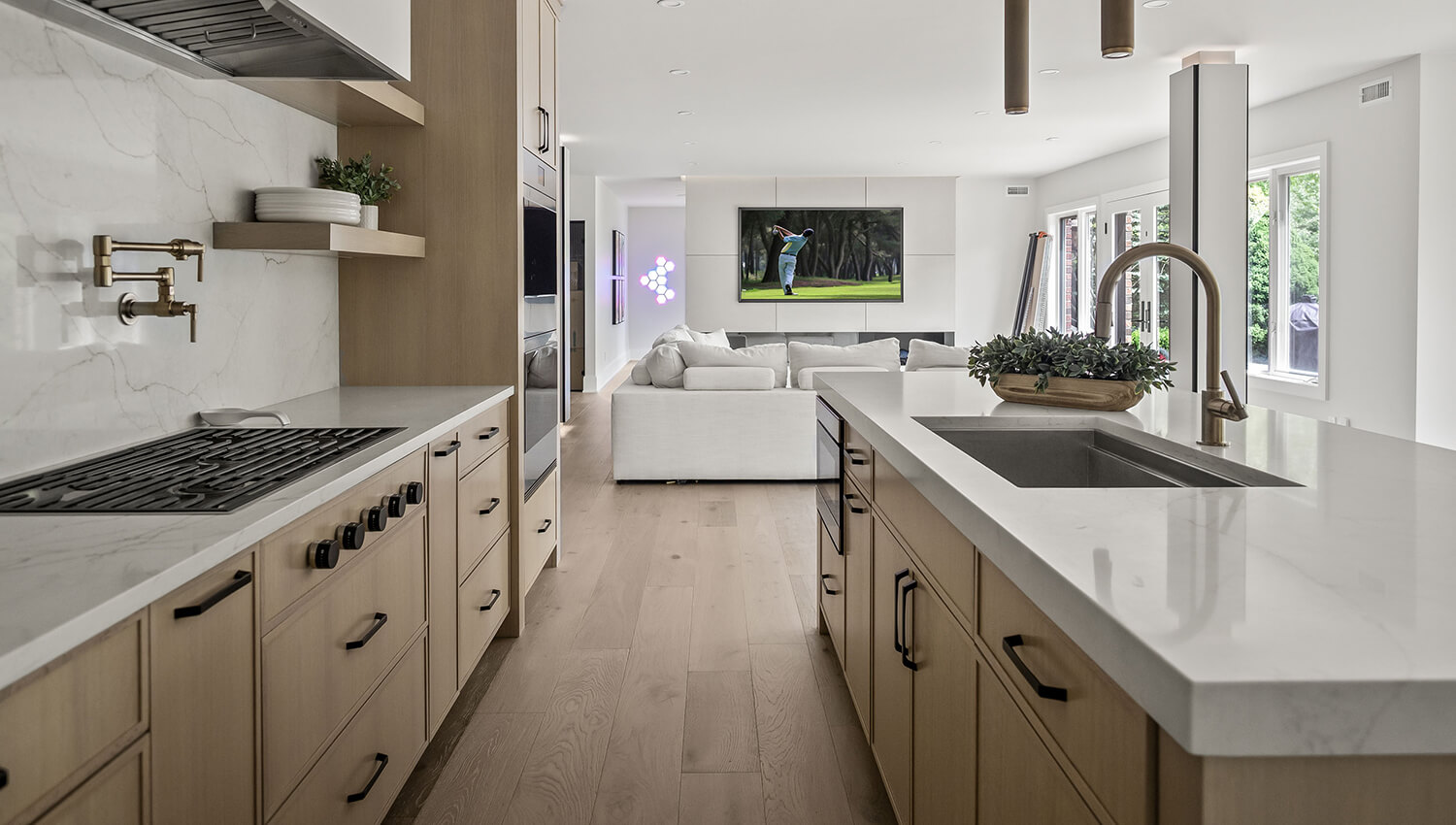 Kitchen design by Sandra Daubenmeyer of KSI Kitchen & Bath in Macomb, Michigan, featuring the Reese door style with the “Alabaster stain on Quarter-Sawn White Oak with a “Canvas” painted modern wood hood. 