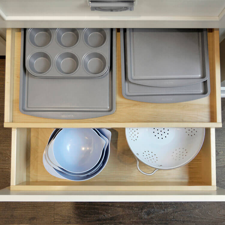Tray storage for baking sheets, muffin tins, pizza pans, trays and more inside a kitchen drawer.