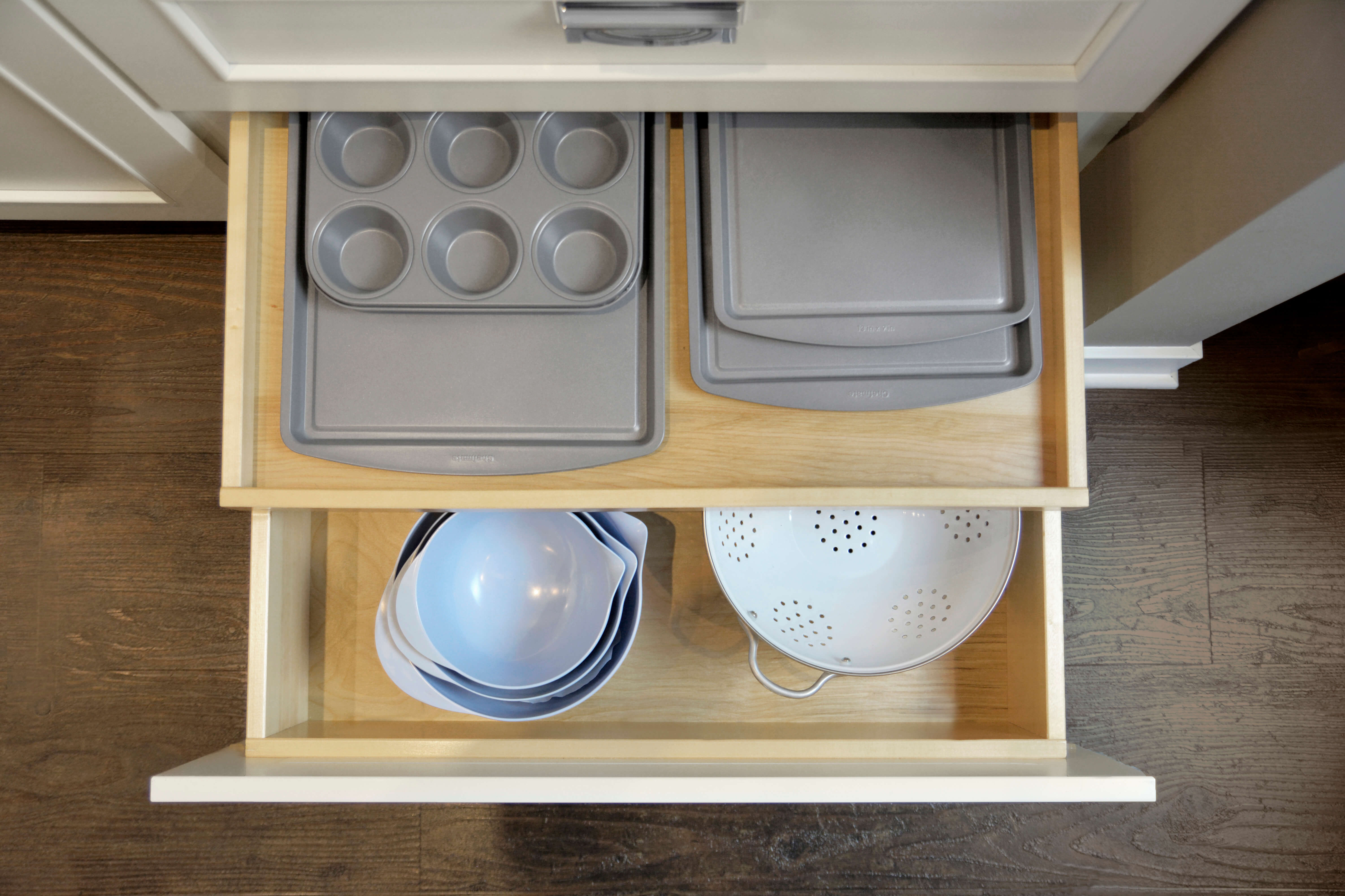 Tray storage for baking sheets, muffin tins, pizza pans, trays and more inside a kitchen drawer.