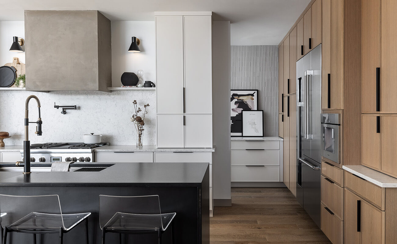 Less is more in this luxurious and simplistic kitchen remodel with skinny shaker doors and a modern hood.