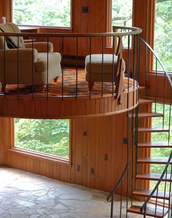A restored mid-century modern home with a spiral staircase.