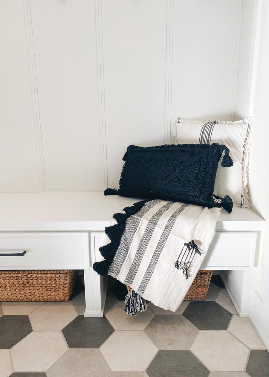 A small boot bench with drawer storage.