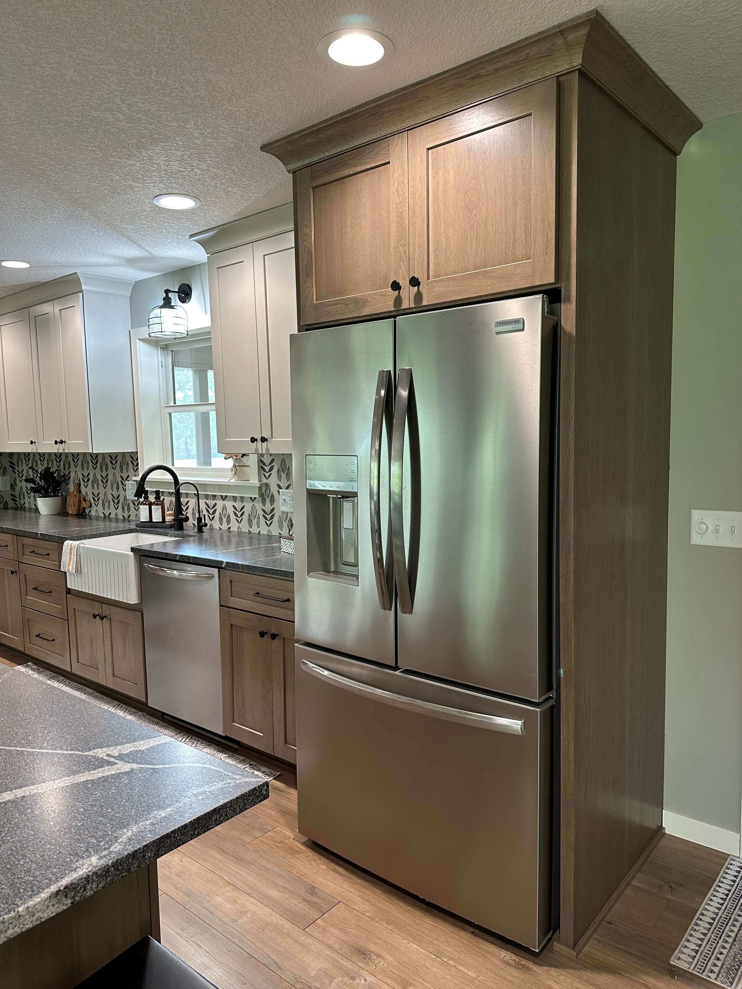 The main fridge with panels on both sides to give it a built-in look.