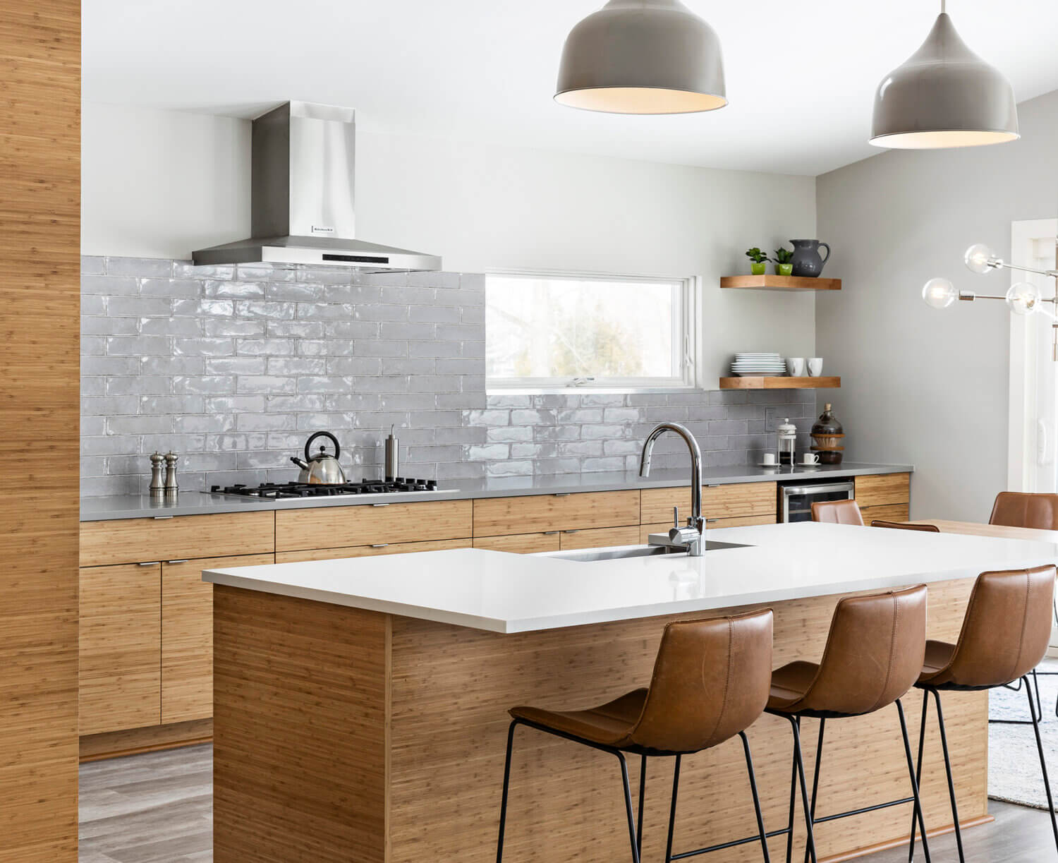 A modern, Asian Zen styled kitchen design with natural bamboo cabinets with a sleek slab door style.