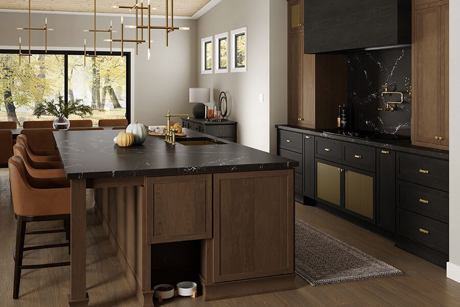 A modern kitchen with traditionally framed cabinets in a mix of brown stained wood and black stained wood.