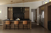 A warm black and brown modern kitchen with a shallow shaker door style.