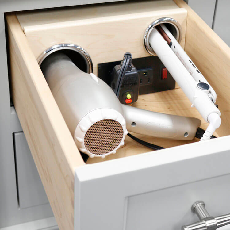 Bathroom cabinet accessory with a vanity grooming drawer for hair dryer and curling iron storage.