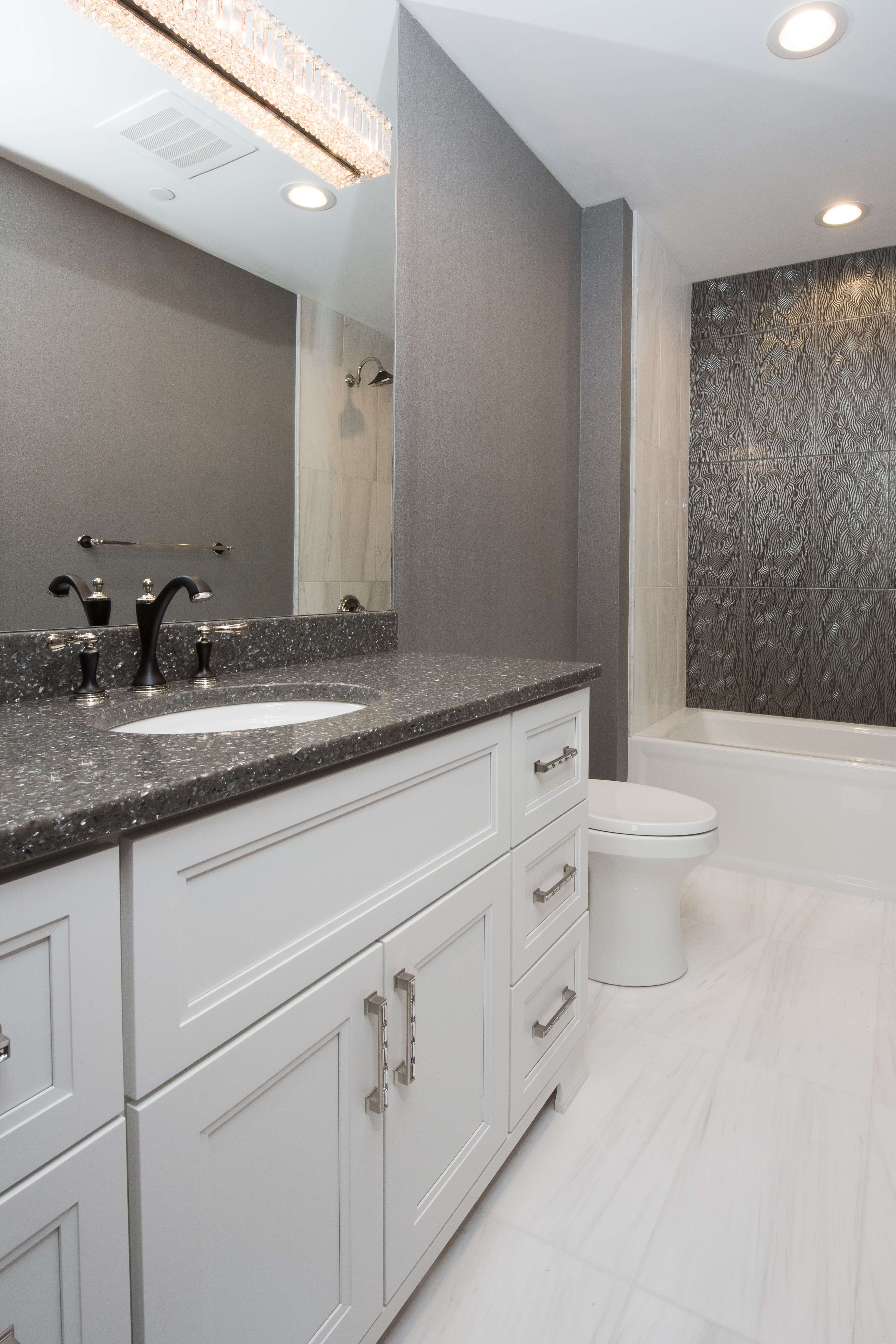 A white painted bathroom vanity with a furniture style look.