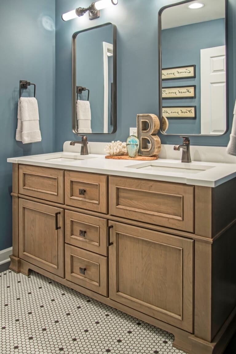 A true-brown stained vanity with double sinks and furniture inspired details.