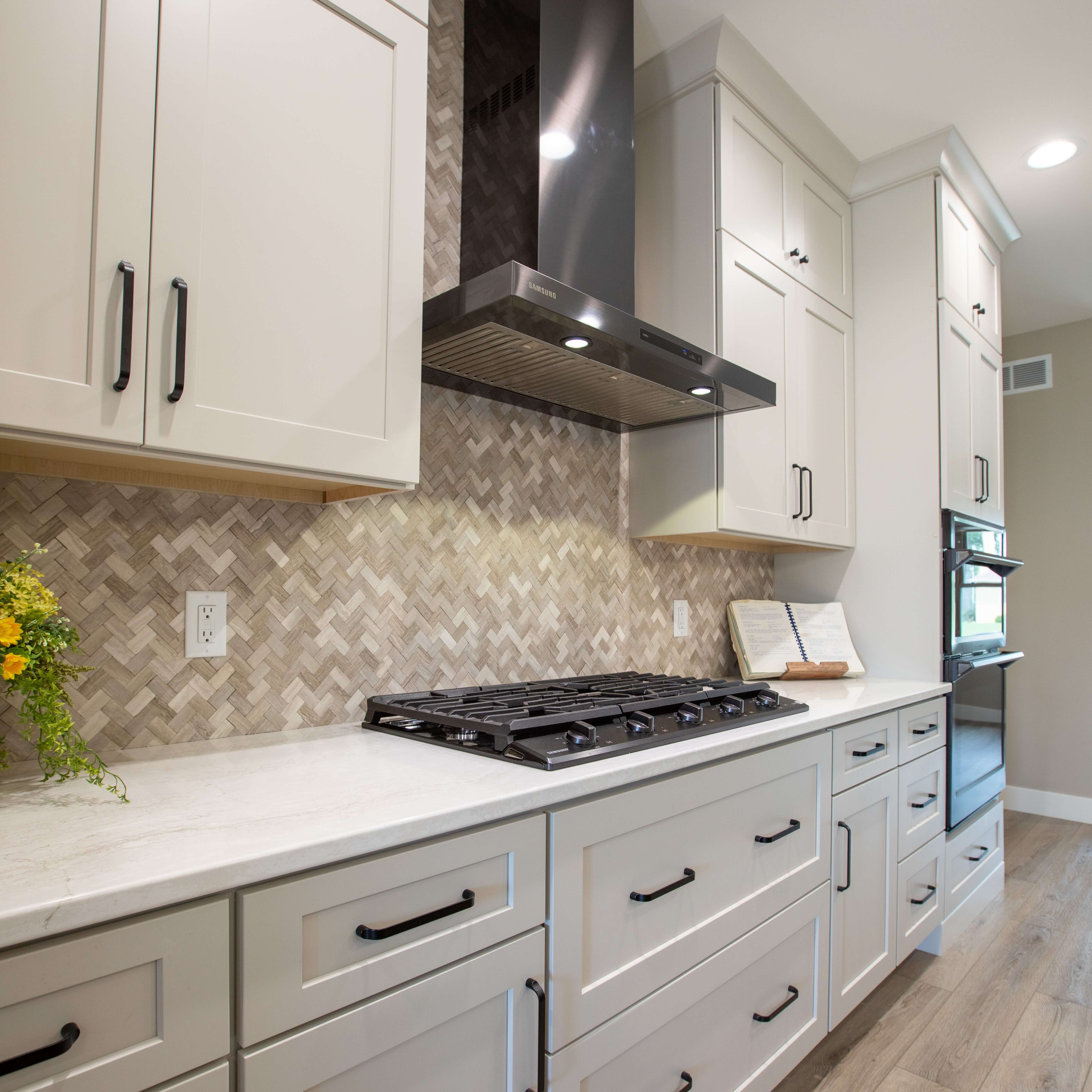 White kitchen cabinets with a muted, tonal hue that's feels cozy and inviting.