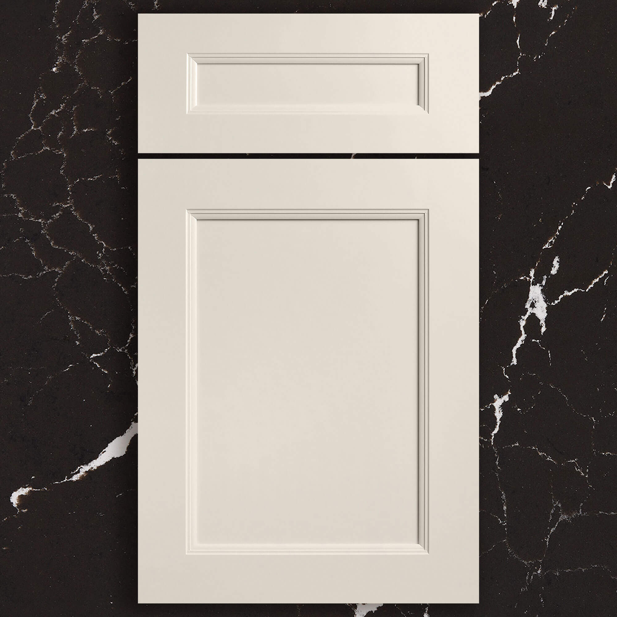 An off-white painted full overlay cabinet door with a flat panel and elegant details on the inside profiles laying on a black quartz countertop.