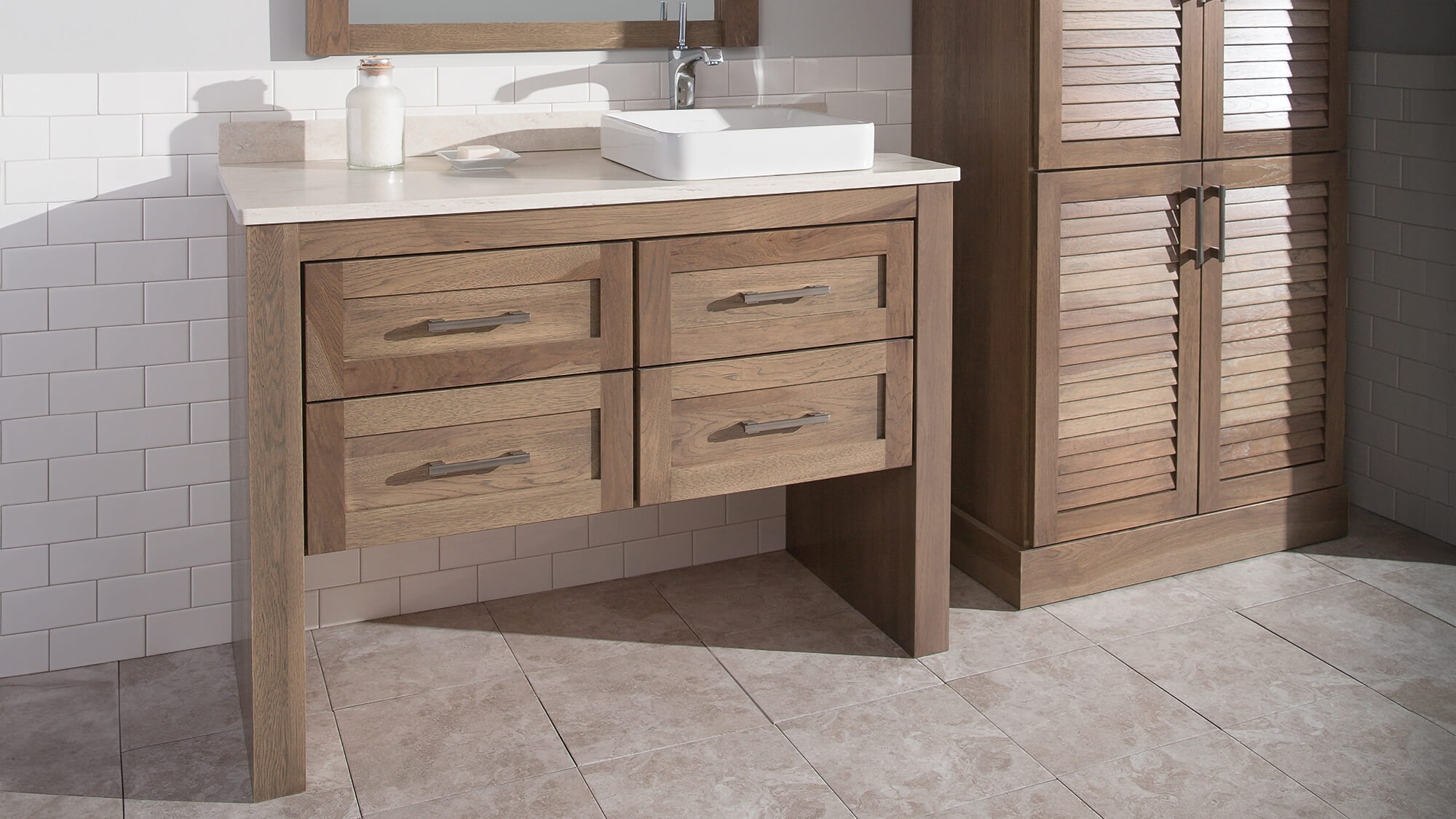 A transitional and modern vanity in a hickory wood with open floor below. Dura Supreme Cabinetry's Furniture Vanity Style #6.