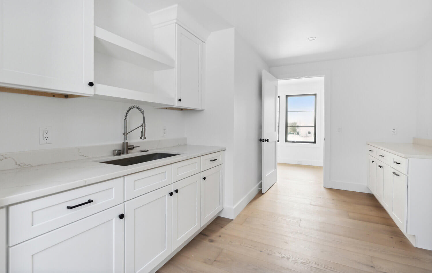 A beautiful all white laundry room design.