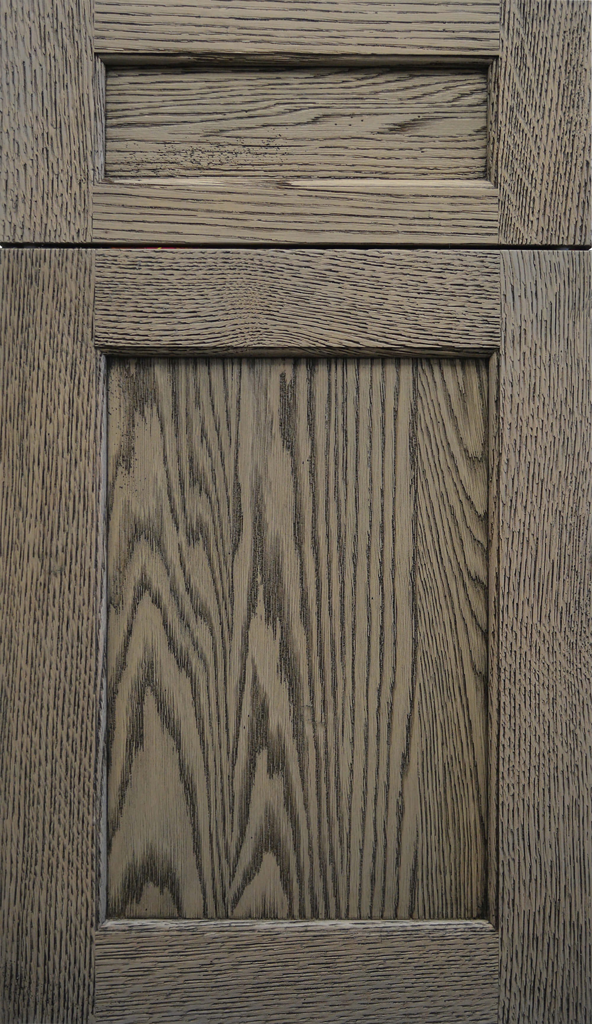 A classic shaker style cabinet door in a weathered oak finish with a medium gray/brown stain color.