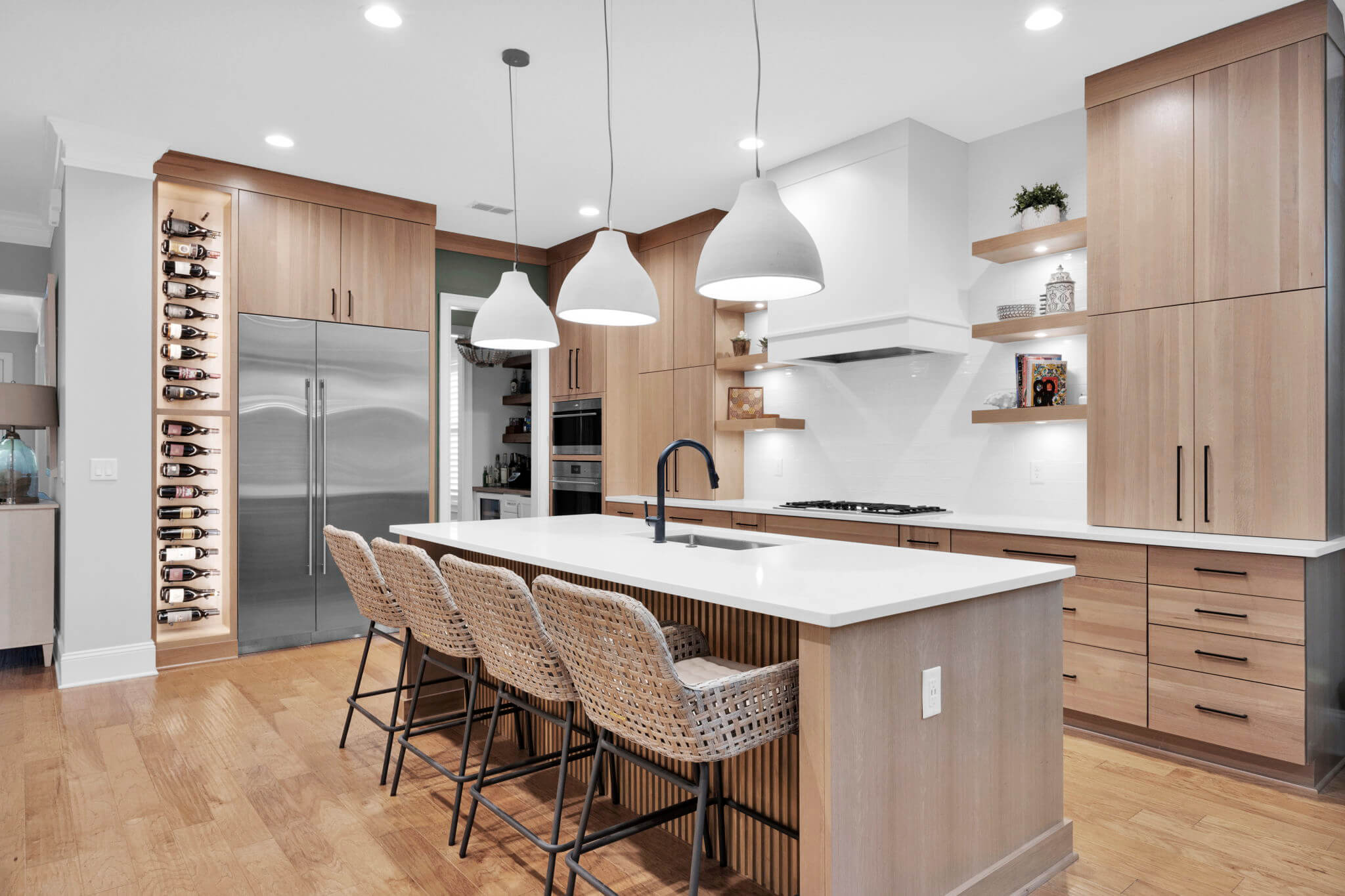 This transitional styled kitchen design combines modern details with the warm, natural grain pattern of quarter-sawn white oak cabinets.