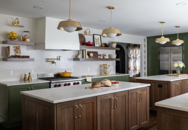 This awe-inspiring U-shaped kitchen design features two expansive kitchen islands and a vibrant, nature-inspired color palette that radiates warmth and energy.