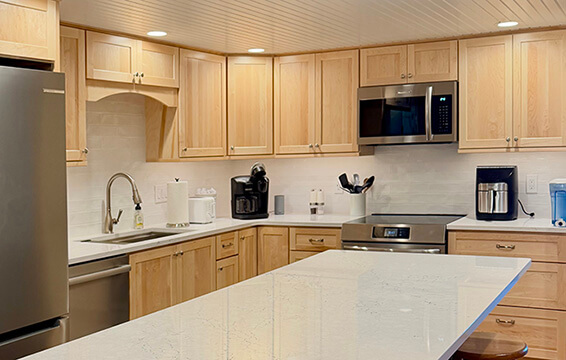 A beautiful kitchen with light stained wood cabinets.